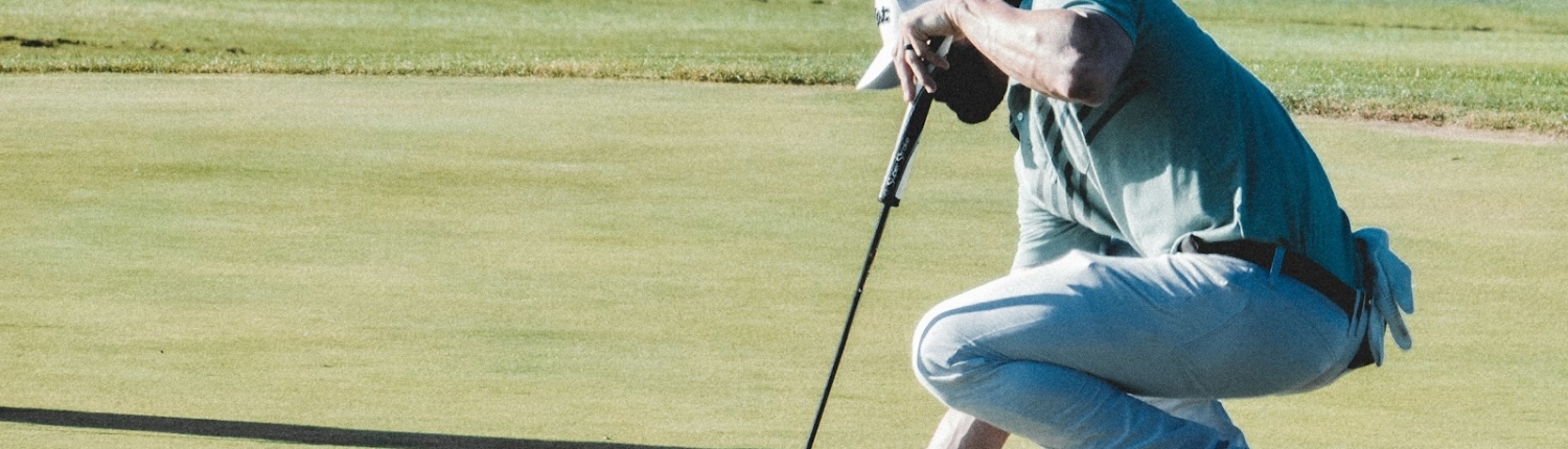 man holding black golf club